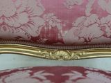 a close up of a chair with a pink upholstered seat