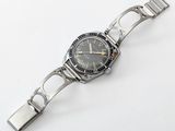 an image of a watch on a bracelet on a white surface
