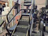 a picture of a gym room with treads and machines