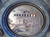 a close up of a meter on the side of a building