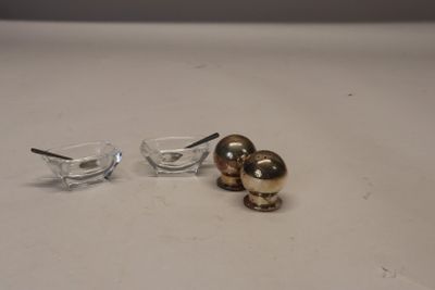 a small glass bowl with a spoon and a small glass bowl with a spoon on it
