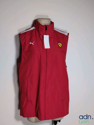 a close up of a red vest on a mannequin stand