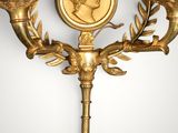 an image of a wall mounted candle holder with a coin on it