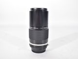 a black camera lens sitting on a white surface