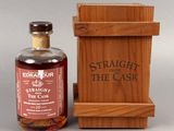 a bottle of straight from the cask next to a wooden box