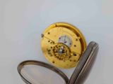 a close up of a pocket watch with a magnifying lens