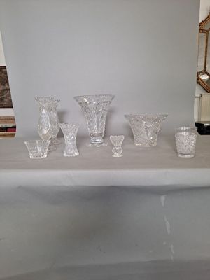 a table with a bunch of glass vases on top of it
