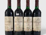 three bottles of wine are lined up on a white surface