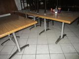 two tables that are sitting in the middle of a room