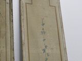 two asian paintings hanging on the wall next to each other