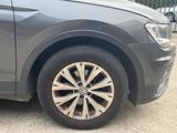 a close up of a car ' s wheel on the road