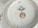 a white plate with a red and green design on it