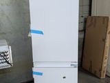 a white refrigerator sitting on a pallet in a warehouse