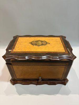 an old wooden box with a decorative design on it