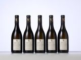 four bottles of wine lined up on a table
