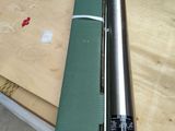 a green mat on the table next to a metal pipe