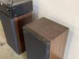 two speakers sitting next to each other on the floor