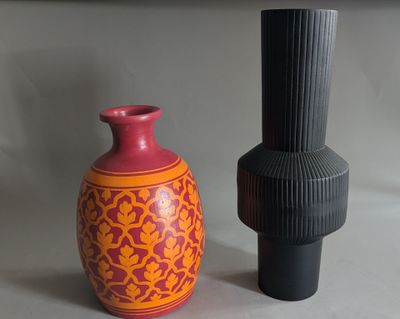 two vases sitting next to each other on a table
