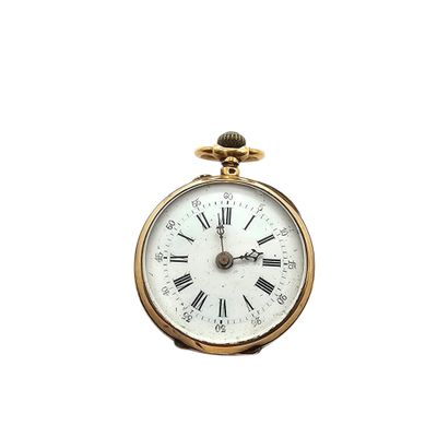 a gold pocket watch with roman numerals on the face