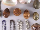 several different types of necklaces and bracelets laid out on a table