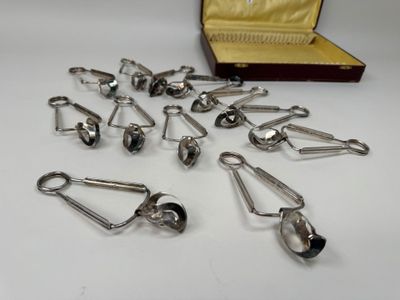 a lot of silver spoons in a case on a table