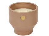 the candle is sitting in a clay pot on a white background