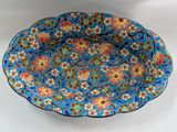 a close up of a blue plate with flowers on it