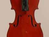 a close up of a red violin with a black bow