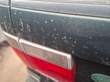 a close up of a car ' s tail light and emblem