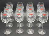 six empty wine glasses are lined up in a row on a table
