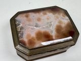 a picture of a box with a stone inside of it