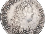 a close up of a silver coin with a woman on it