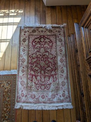 a rug on the floor in a room next to a pair of shoes