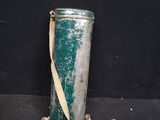 an old tin can with a strap on it