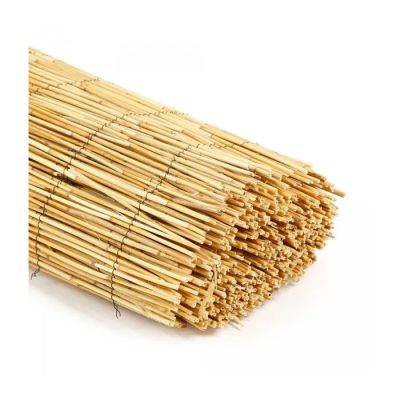a pile of bamboo sticks on a white surface