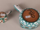 a small teapot and a small teapot on a table
