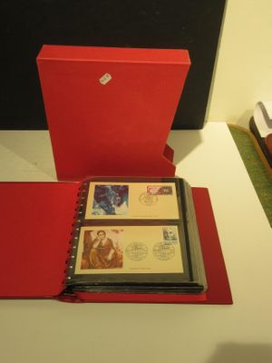 a red folder with a picture inside of it on a desk