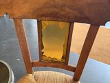 a wooden chair with a mirror on the back of it