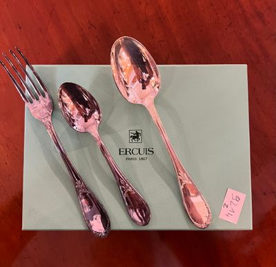 three spoons and a fork sitting on a table