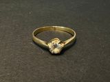 an image of a gold ring with a stone in the middle
