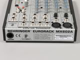 a close up of a mixer with a lot of knobs on top of it