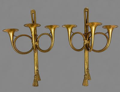 pair of antique brass candelabs on a gray background