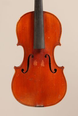 an old violin with a bow hanging from it ' s back