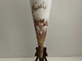 a vase that is sitting on a stand on a table
