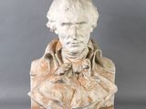 statue of a bust of a man with a bow tie on a gray background