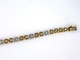 a close up of a gold and diamond bracelet on a white background
