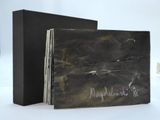 a black book with writing on it sitting on a table