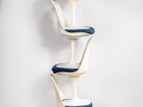 an image of a stack of three chairs with a blue seat