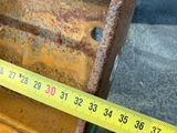 a measuring tape on the side of a piece of metal