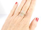 a woman ' s hand with a diamond ring on it